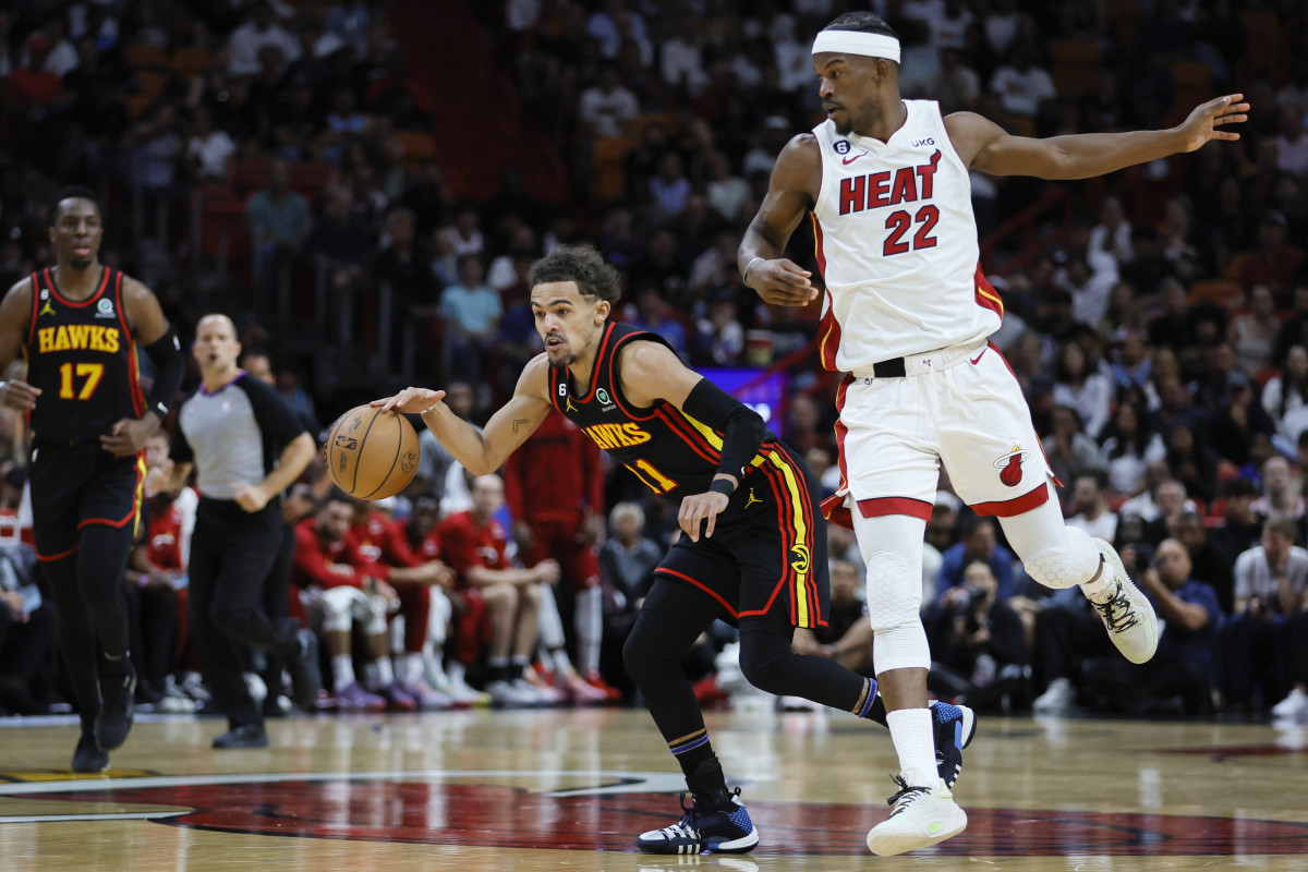 Atlanta Hawks guard Trae Young dribbles past Miami Heat forward Jimmy Butler.